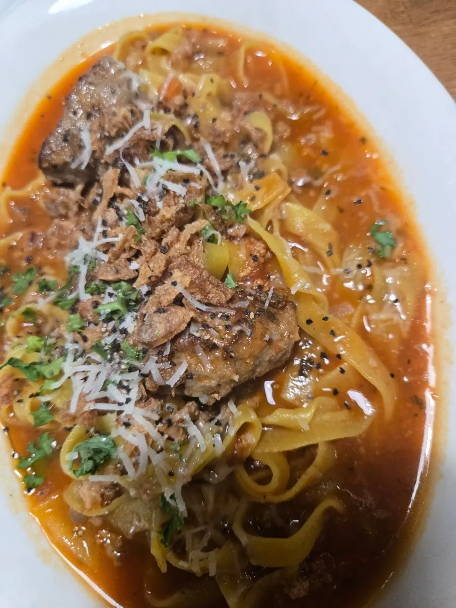 Rich ragù sauce with large meatballs