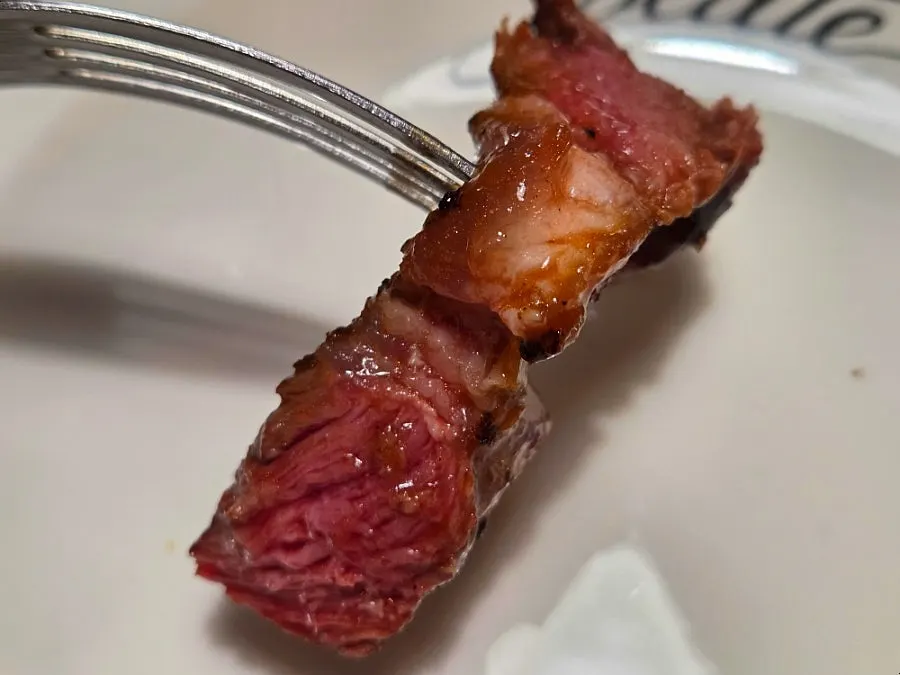 Steak plated with grilled napa cabbage, tomato, and potato purée