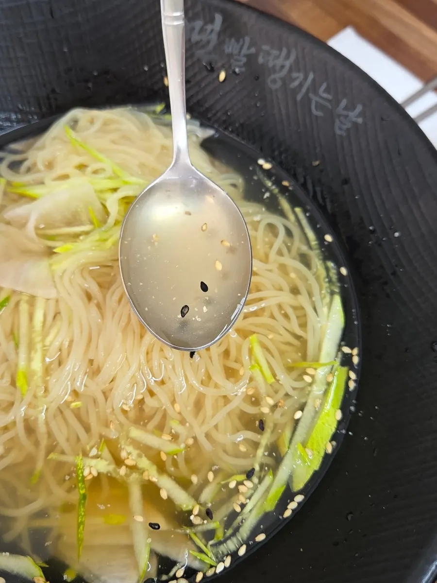 Close-up of water milmyeon toppings and clear broth