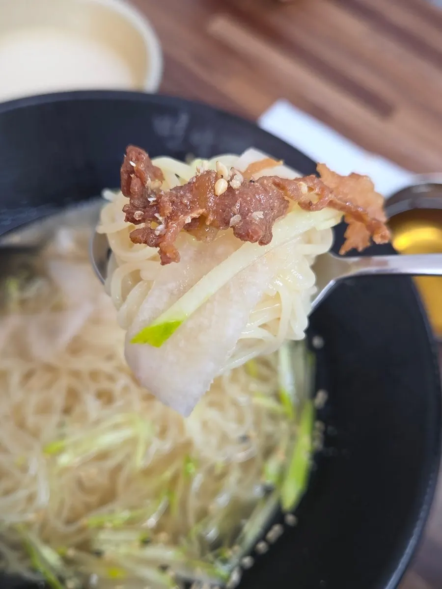 Water milmyeon noodles lifted with chopsticks