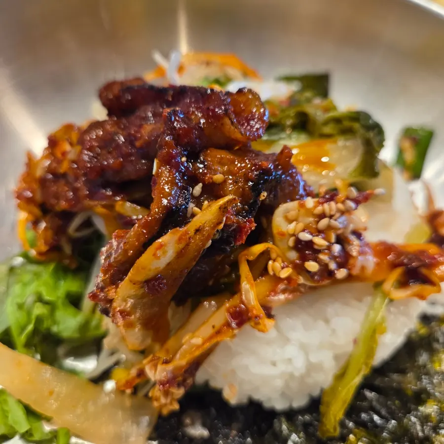 Rice mixed with bean sprouts and yeolmu kimchi in a large bowl