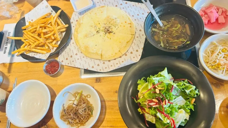 A full spread with salad, mukbap and wood-fired pizza