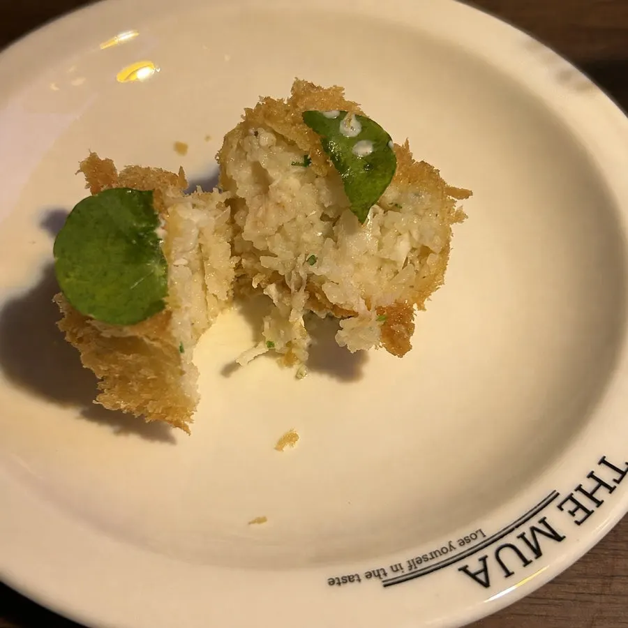 Lobster croquette cut in half showing the filling
