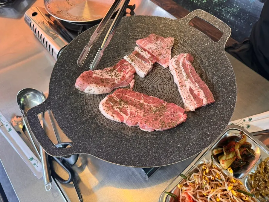 Grilled aged pork being eaten inside the tent