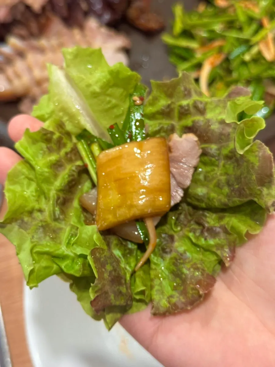 Bossam served with dried radish strips