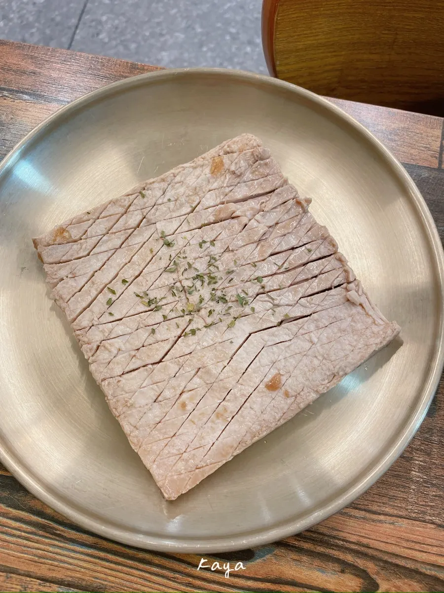 Thin-sliced pork belly cooking on the grill