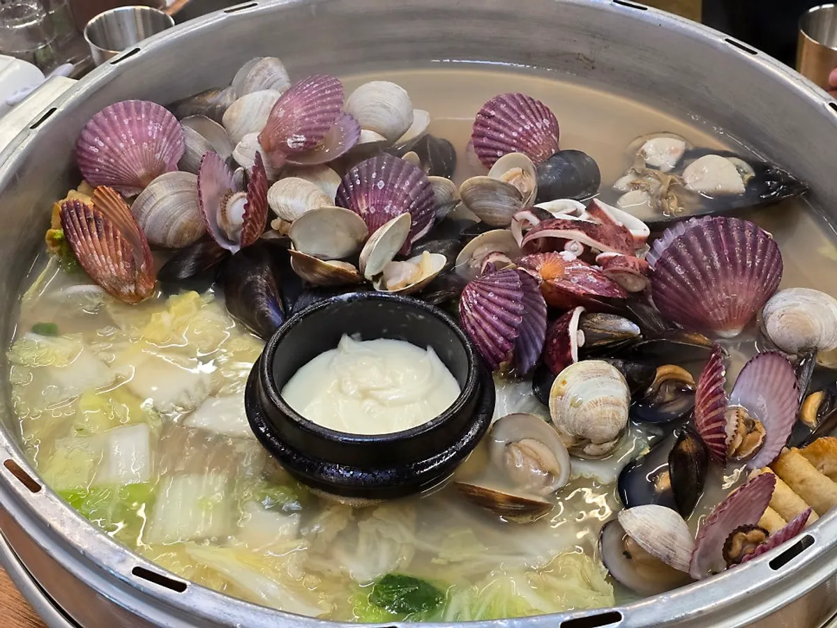 Olla de almejas servida en una cazuela grande
