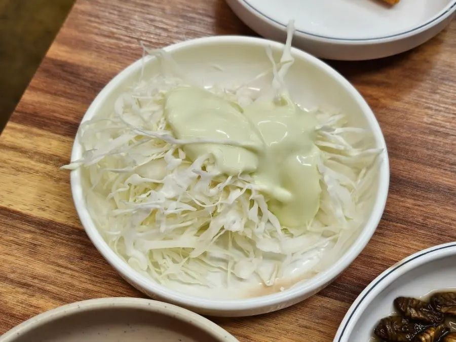 Cabbage salad and side dishes served as part of the basic spread
