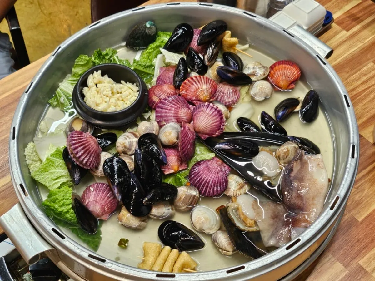 Clam hot pot steaming at the table