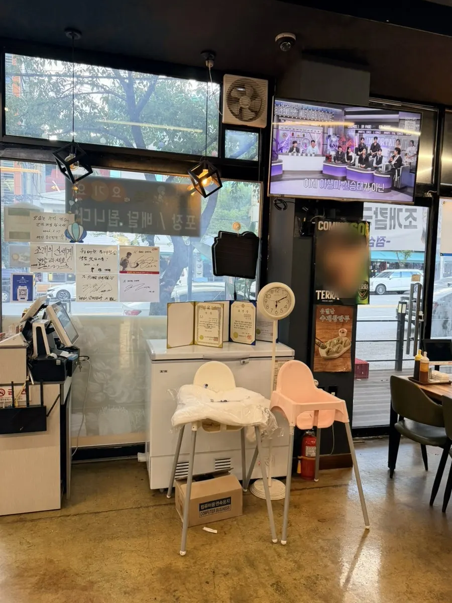 Vertical shot of the interior walkway and seating at Widaehan Jogae Jeongol
