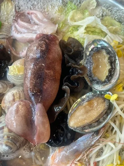 A bowl of seafood kalguksu with the seafood already eaten out
