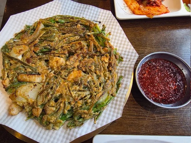 The table set with seafood kalguksu and seafood pajeon together