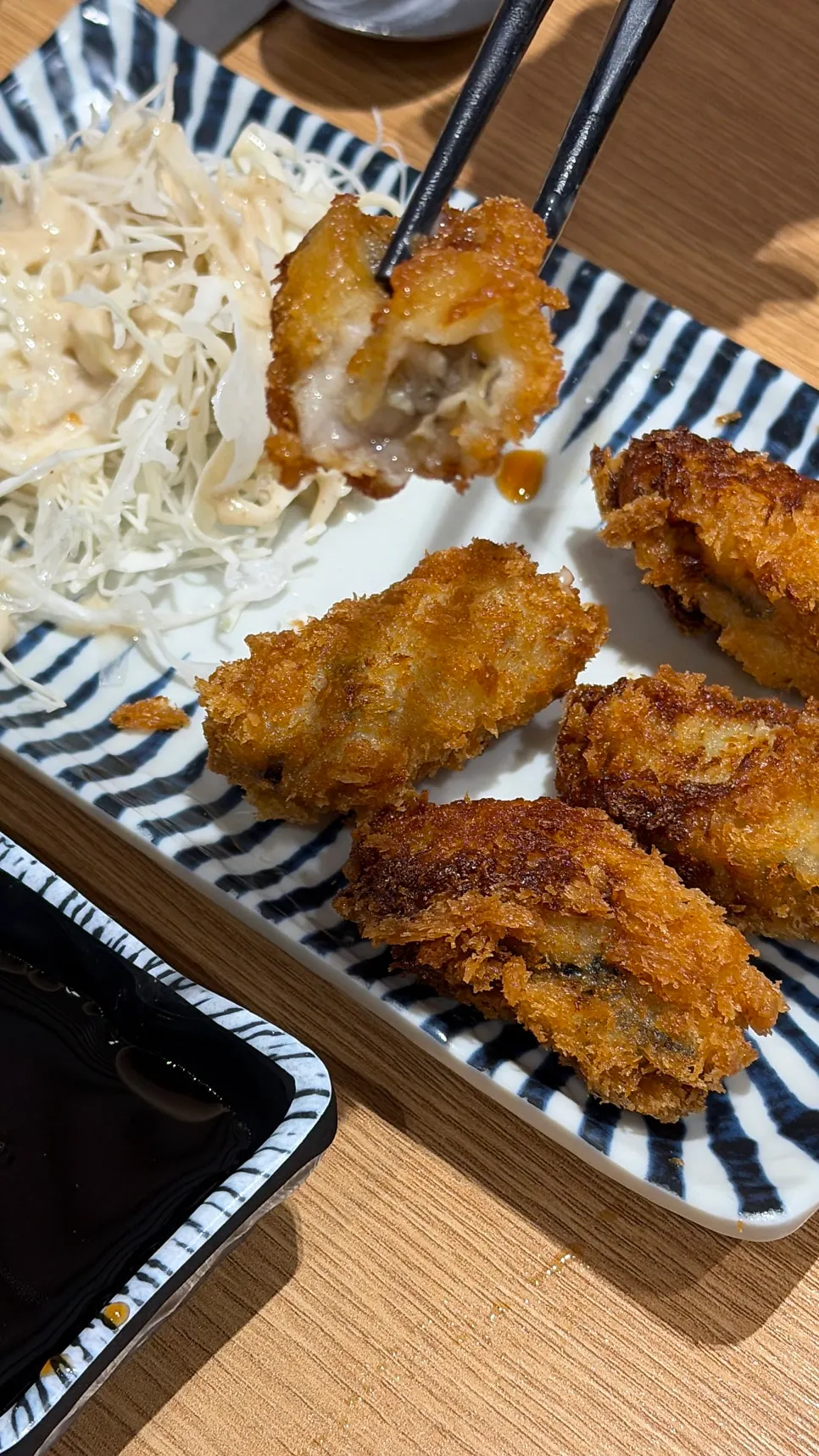 Cross-section of the oyster tempura with dipping sauces