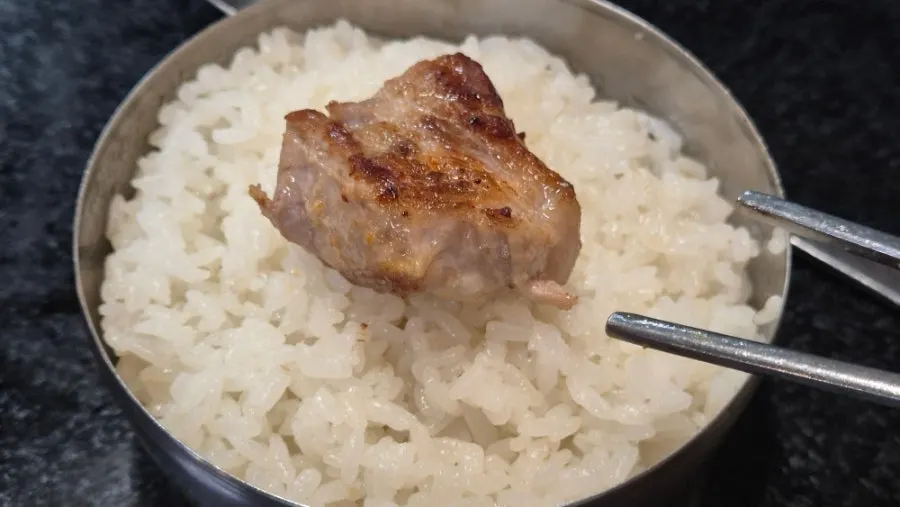구운 김치와 함께 싸 먹는 삼겹살 한 점