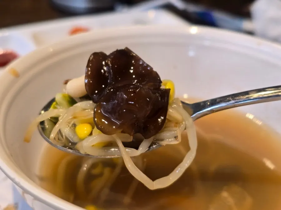 Vegetables and seafood beginning to boil in the seafood pot