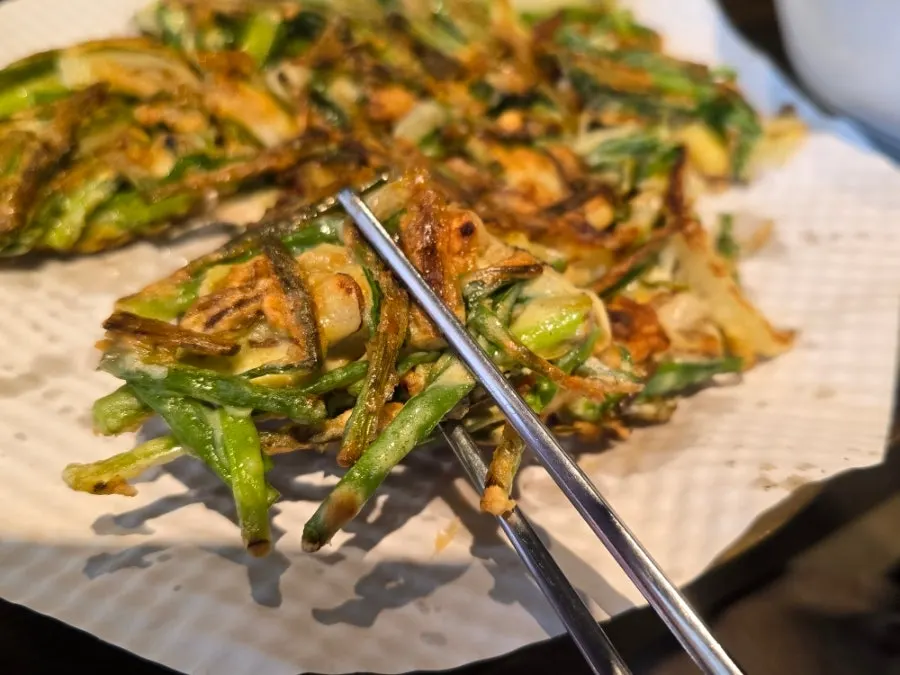 A piece of pajeon full of scallions and seafood