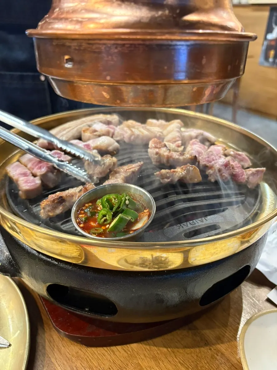Side dishes and various dipping sauces for the meat at Daejisikdang Mohyeon