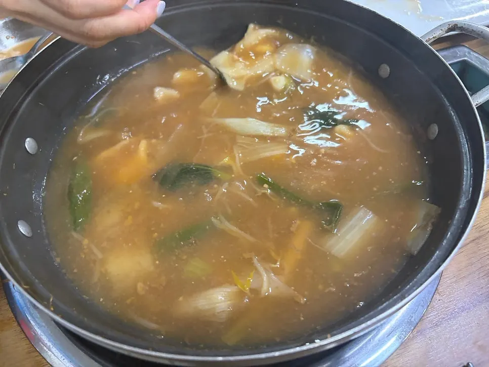 Dumpling dough cooking in the broth