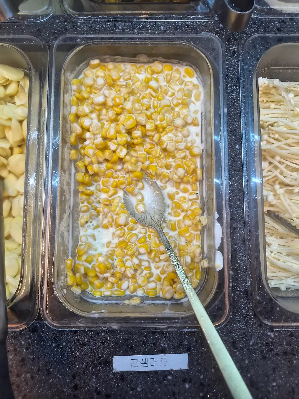 Self-serve bar corner lined with side dishes