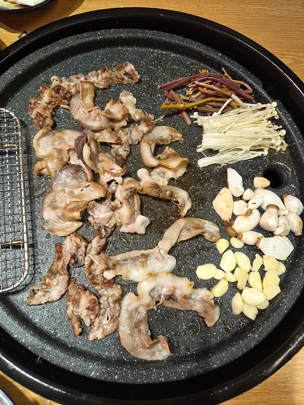 Thin-sliced meat grilling fast on a high-heat burner