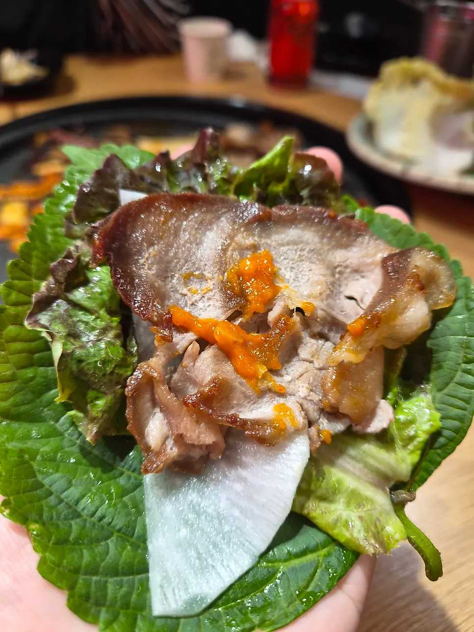 Thin-sliced meat wrapped in a vegetable leaf