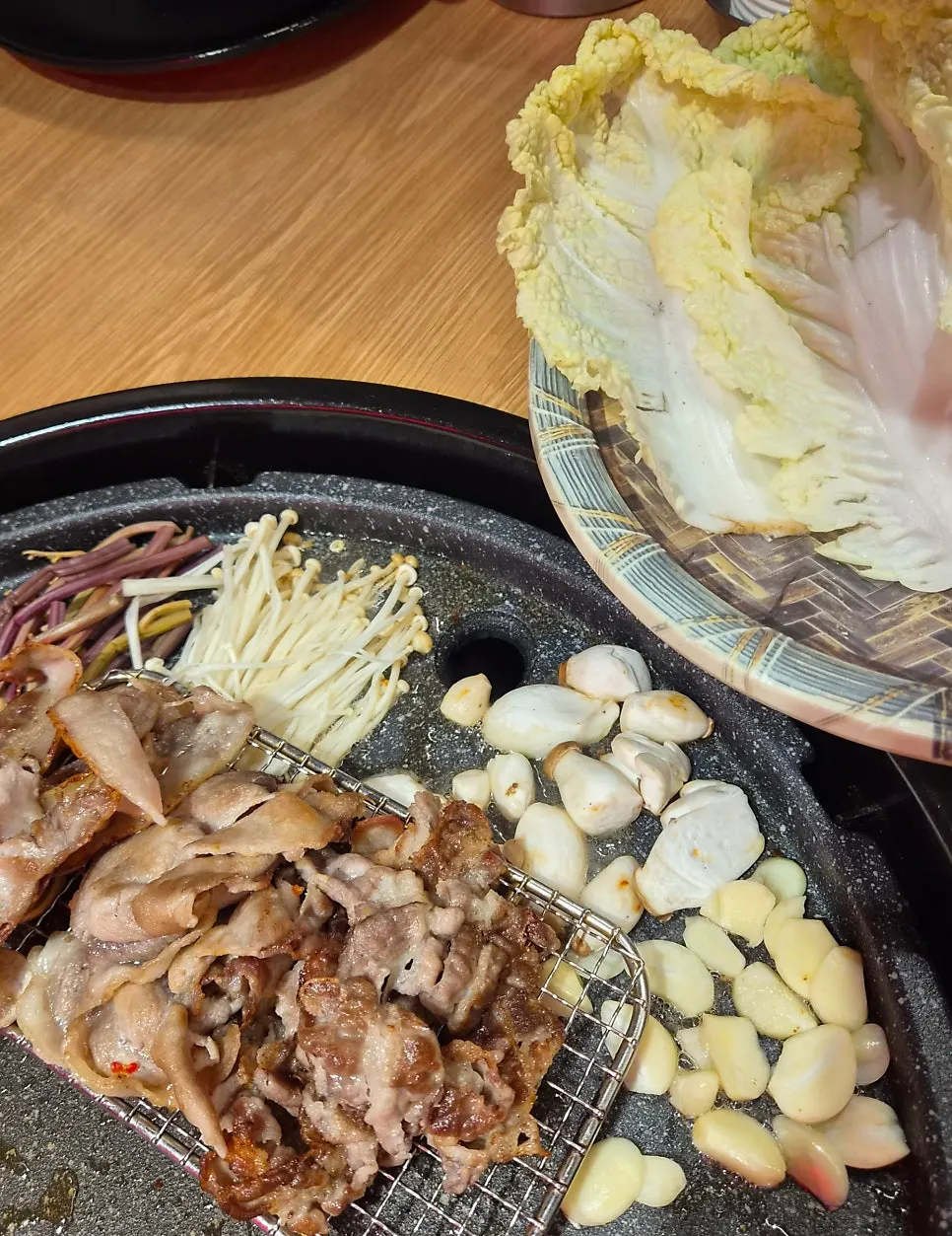 Table spread of meat enjoyed together with self-serve bar side dishes