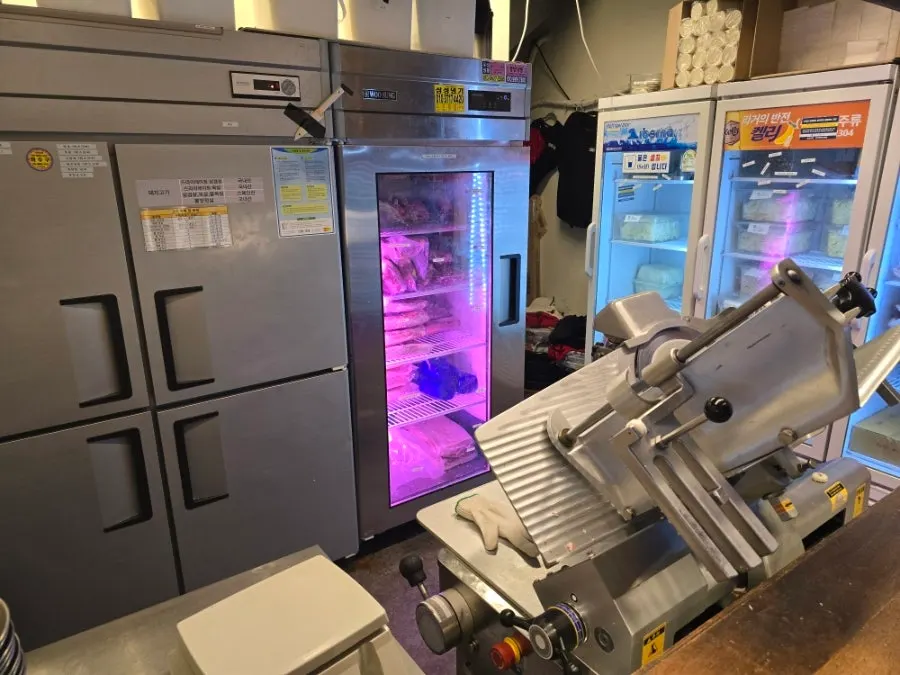 Large meat-slicing machine set up on one side of the restaurant