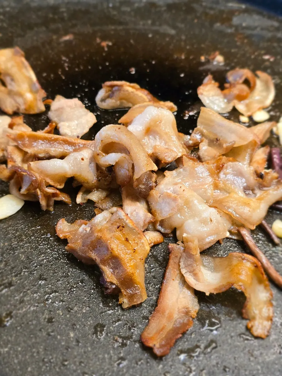 Crispy well-cooked pork belly on the grill
