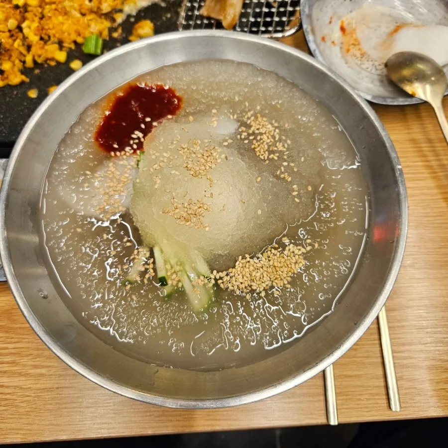 Mul-naengmyeon served in a stainless bowl