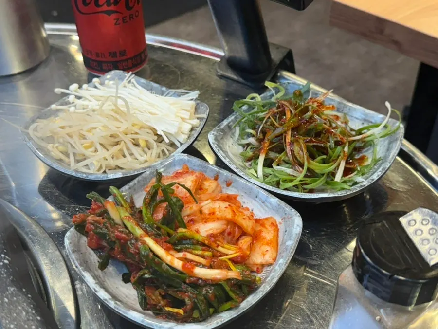 Kimchi and bean sprouts grilling together on the pan