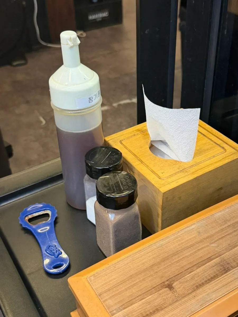 Individual dishes of salt, pepper, and sesame oil