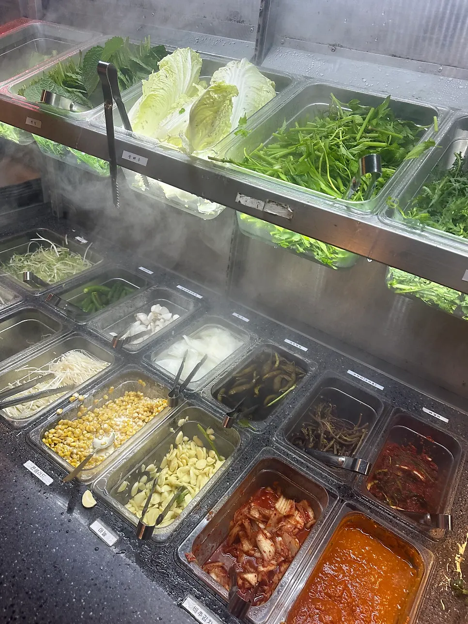 Self-serve bar side dishes with wrap vegetables, shredded green onion, and pickled radish