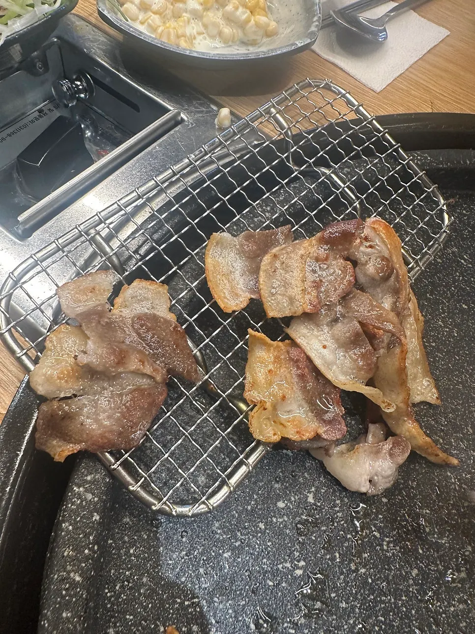 Thin-sliced pork grilled crisp on high heat next to the warming plate