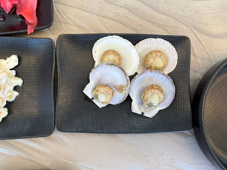 Side seafood dish served alongside the sashimi