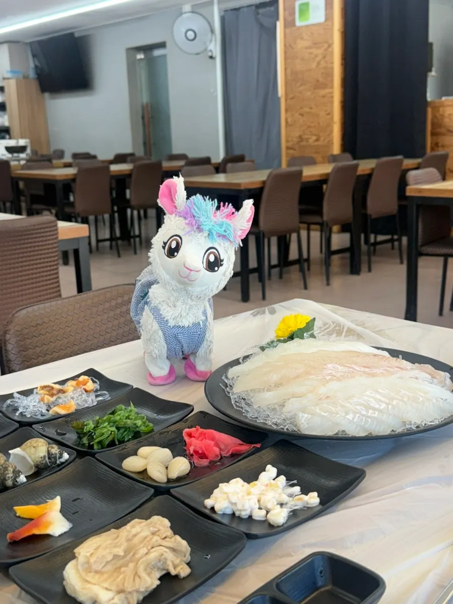 Table set with flounder sashimi and banchan