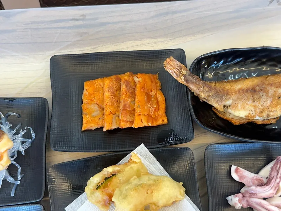 Additional side dishes including squid and fried food