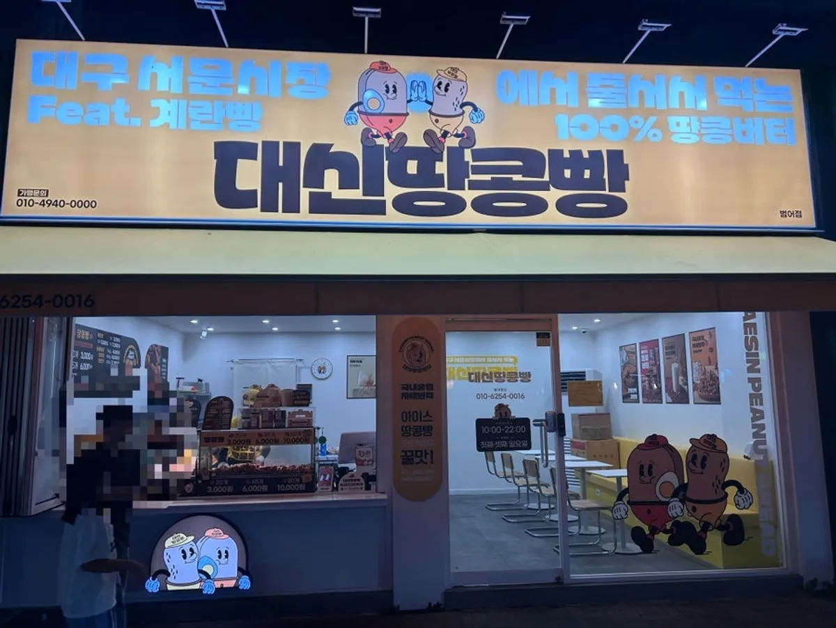 Daesin Peanut Bread Beomeo Direct Store storefront and sign lit up at night