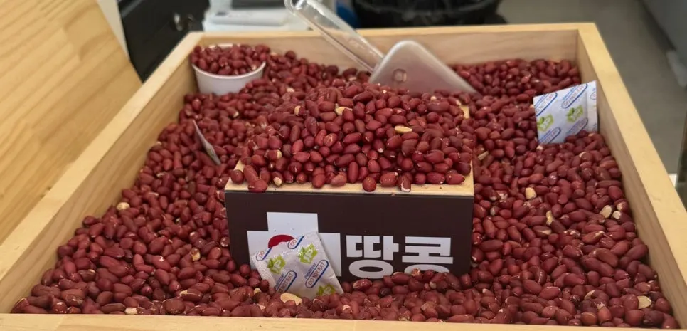A pile of reddish peanuts on one side of the store