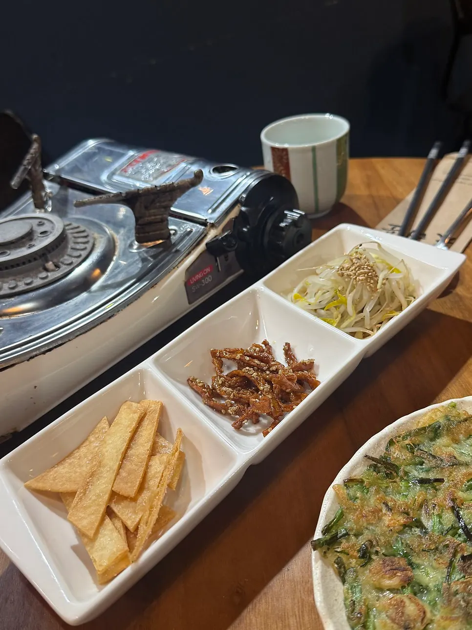 Table with side dishes and pajeon laid out