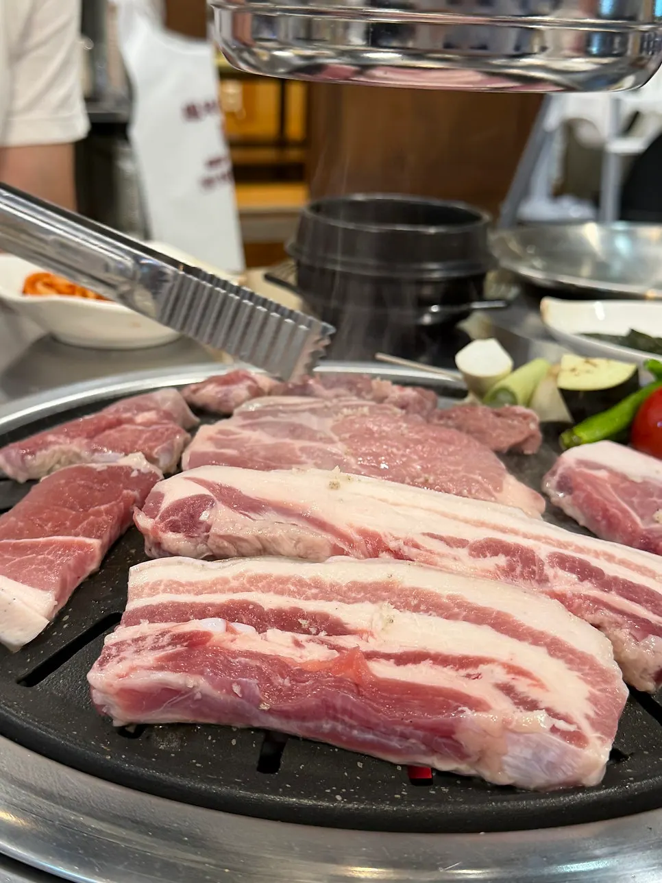 Black pork grilling over charcoal