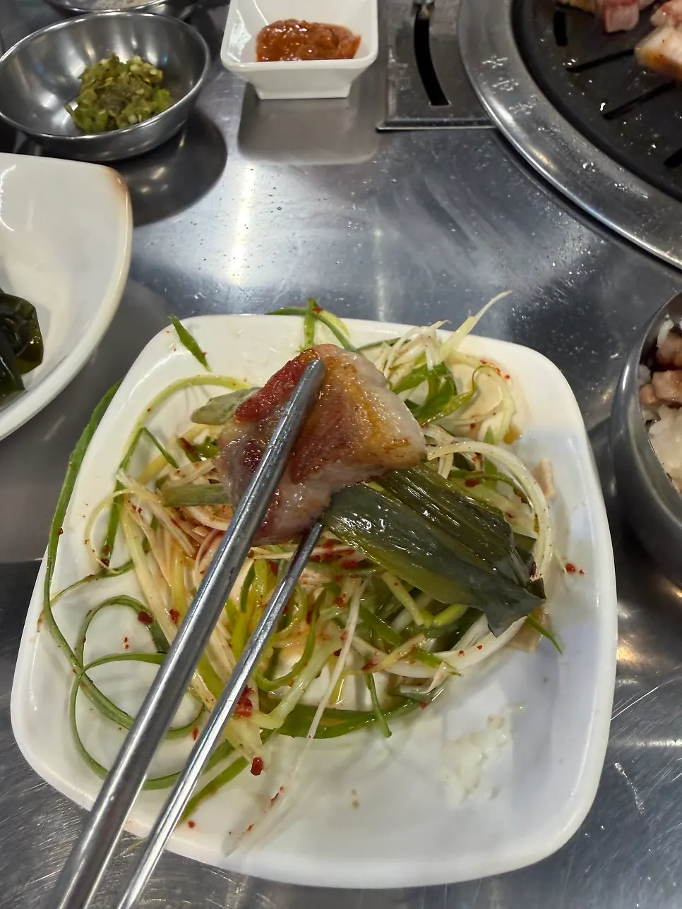 A single piece of black pork picked up with chopsticks