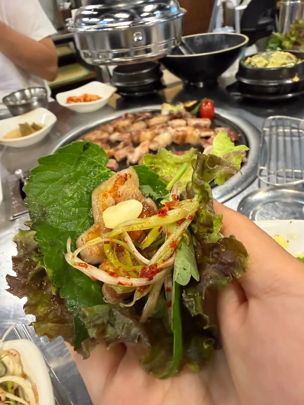 Black pork topped with lettuce wrap and myeong-i namul