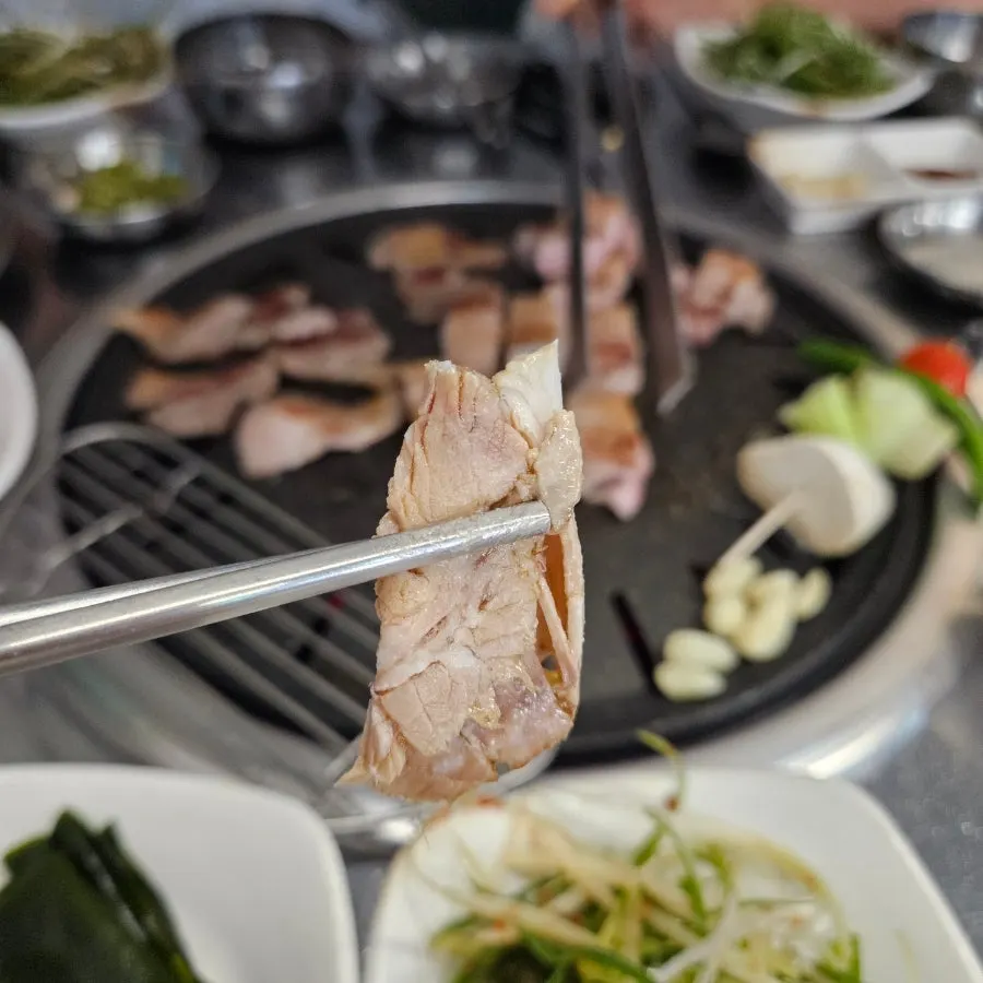 A piece of black pork wrapped in wild garlic leaf