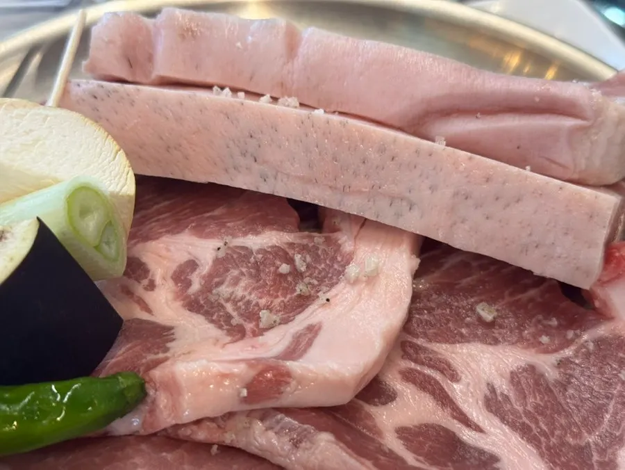 Black pork grilling over charcoal