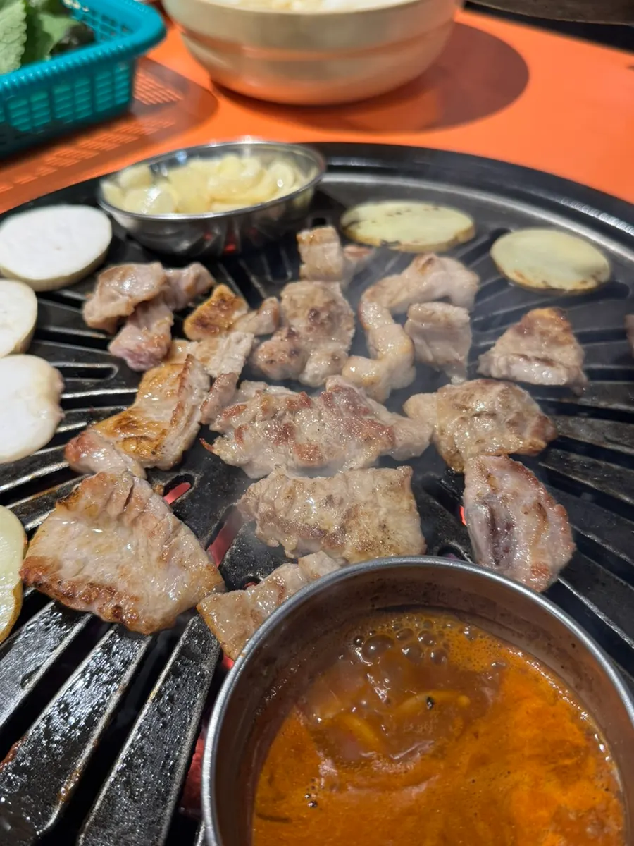 Raw ribs cooking golden brown on the cast-iron pan