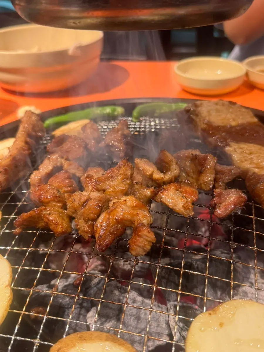 Marinated ribs cooking on the charcoal grate