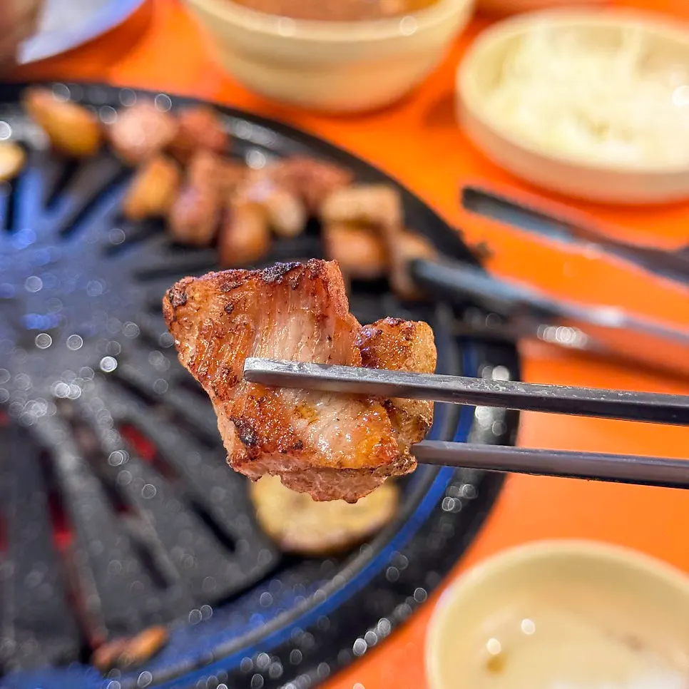 Whole pork jowl cooking on the grill