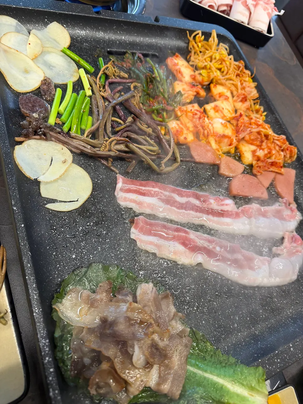 Thin-cut pork belly placed on the grill