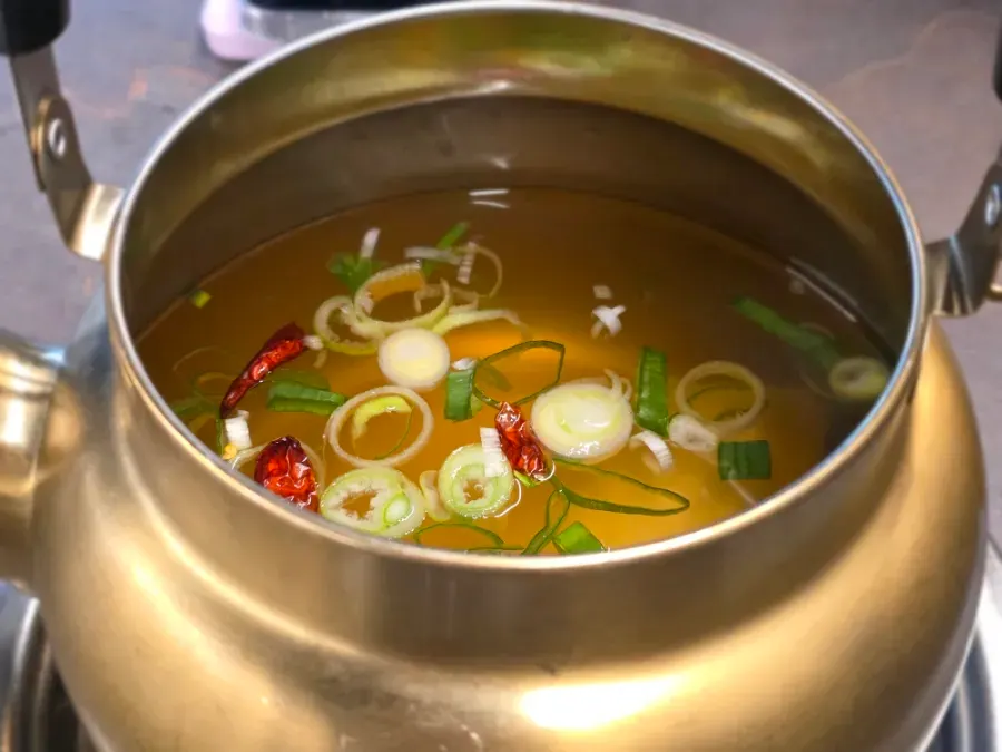 Free fish cake soup served in a metal kettle