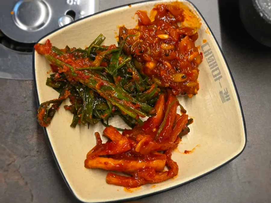 Squid jeotgal with nuts, green onion kimchi, and dried radish strips
